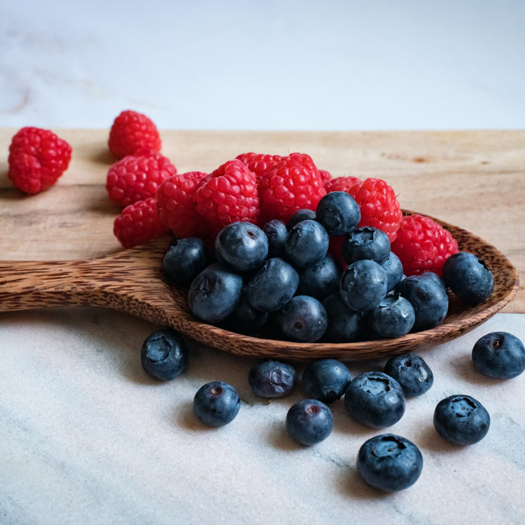 blueberries and raspberries sprinkled on the counter