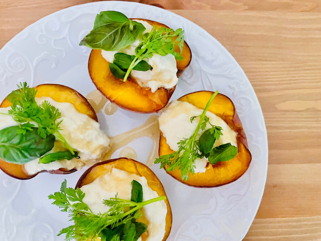 Peaches topped with ricotta, honey, and herbs
